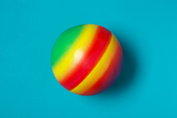 New bright kids' ball on light blue background, top view