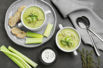 Delicious celery soup served on gray table, flat lay