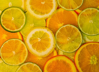 Slices of orange, lemon, lime, natural background, fresh fruits, vitamins, healthy food, top view.