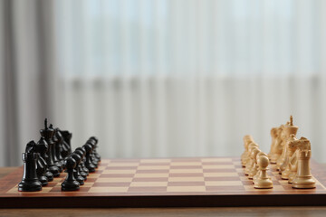 Set of chess pieces on checkerboard before game, selective focus. Space for text