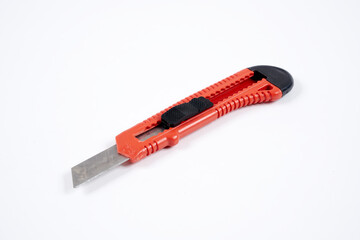 red utility knife on a white background
