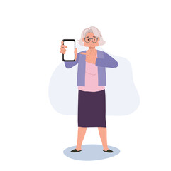 Modern Senior with Technology concept. Elderly Woman Pointing Finger at Smartphone. Active senior Using Smartphone for Online Interaction