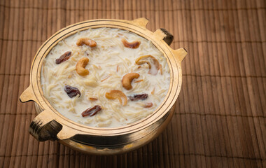 Semiya payasam with copy space Onam special sweet dessert arranged in traditional golden bowl, vermicelli milk cream desserts