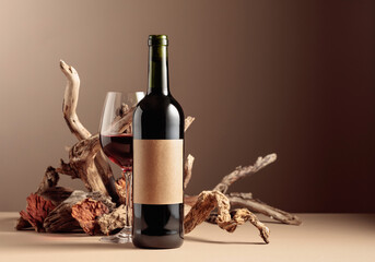 Bottle and glass of red wine with a composition of old wood.