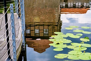 Reflection of an old fortress in the water with lilies in the foreground in Germany