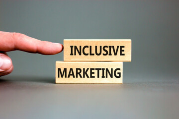 Inclusive marketing symbol. Concept words Inclusive marketing on beautiful wooden block. Beautiful grey table grey background. Businessman hand. Business inclusive marketing concept. Copy space.