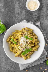 Fussili pasta with basil pesto sauce, parmesan cheese and pine nuts. Traditional Italian food.