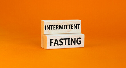 Intermittent fasting symbol. Concept words Intermittent fasting on beautiful wooden block. Beautiful orange table orange background. Healthy lifestyle intermittent fasting concept. Copy space.