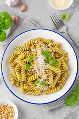 Fussili pasta with basil pesto sauce, parmesan cheese and pine nuts. Traditional Italian food.