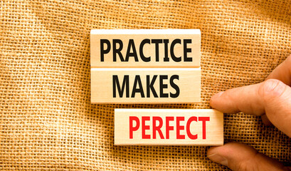 Practice makes perfect symbol. Concept words Practice makes perfect on wooden block. Beautiful canvas table canvas background. Businessman hand. Business practice makes perfect concept. Copy space.