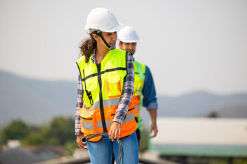 Electrician pulling wire into PVC  pipe electrical engineering female Installing Solar Cell panels...