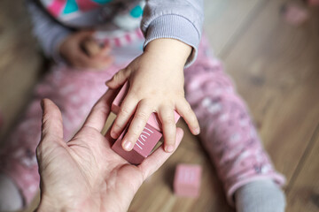 Closeup photographs of children toys - wooden bricks in soft mild subdued colours.