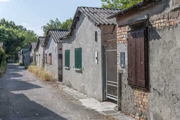 Fototapeta na wymiar very small fishermen houses on narrow street at Punta Sdobba village, Grado, Friuli, Italy