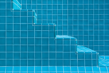 Swimming pool staircase with aqua coloured tiles in close-up detail