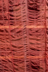 Building under construction covered in scaffolding with protective textile sheets