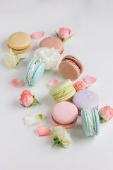 Top view Set Beautiful colorful French macaroons and flowers. Spring Flat lay white background