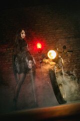 Fototapeta na wymiar Young beautiful girl with dark hair on the old motorbike.