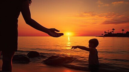 A child and mother s hands touch at sunset by the seaside