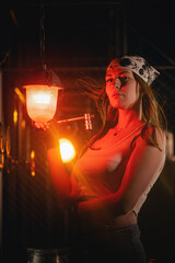 Fototapeta na wymiar Girl with the wrench tool posing in the dark. Mechanic concept.