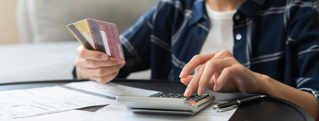 Business financial concept, stressed asian young business woman using calculator for calculate...