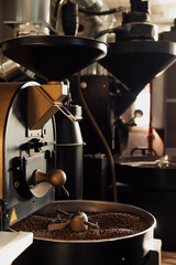 Fototapeta na wymiar Professional machine in process of roasting and mixing coffee beans in modern industrial factory