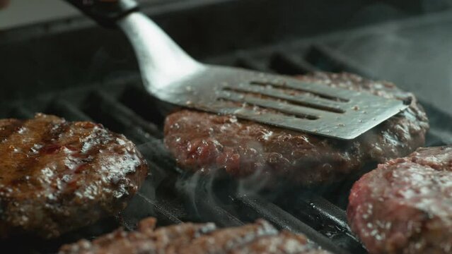 Hamburger on grill in slow motion