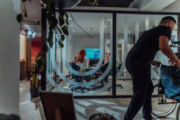 In a modern office, a professional team of videographers captures the essence of creativity and innovation as they film a group of young entrepreneurs, symbolizing collaboration and ambition in the