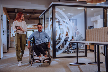 Young business colleagues, collaborative business colleagues, including a person in a wheelchair,...