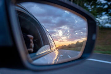 Sunset in car mirror, reflection from the nature