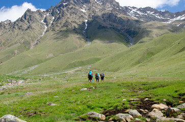 a group of tourists is walking along a mountain trail.hiking.people in the mountains.