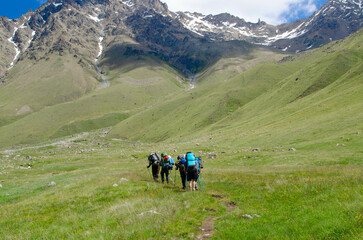 a group of tourists is walking along a mountain trail.hiking.people in the mountains.