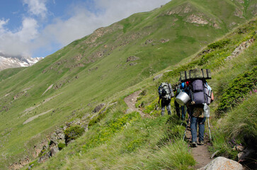 a group of tourists is walking along a mountain trail.hiking.people in the mountains.