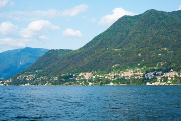 Fototapeta na wymiar Beautiful view of Como Lake or Lago di Como in summer. Popular tourist attraction in Lombardy, Northern Italy.