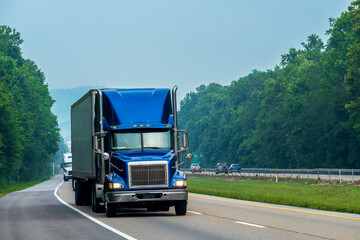 Blue Tractor-Trailer Rig Cruises An Interstate Highway