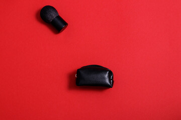 Makeup brush on red background. Kabuki brush for applying powder.