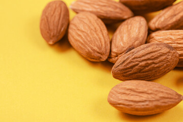 Almonds on a yellow background.  Macro photo.