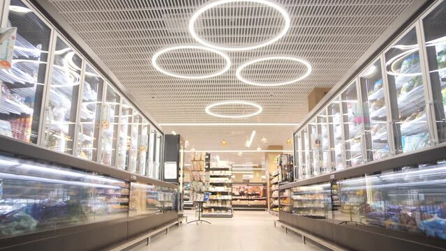 Shopping row with food refrigerators in a large grocery shopping center 