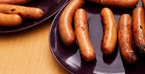 Homemade Sausages baked on fire lie a plate.