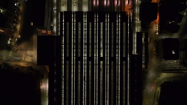 Top down panning footage of roofed platforms on Main Train Station. Illuminated railway infrastructure at night. Zurich, Switzerland