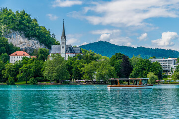 A view of boat traffic passing the church on Lake Bled in Slovenia in summertime