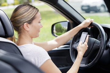 a woman texting while driving