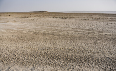 Panoramic view of the Kazakh steppe with ditches from the water and chalk slopes, the shape of limestones in the evening in the steppe