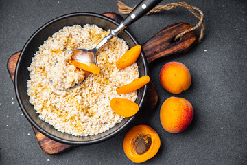oatmeal porridge fresh apricot tasty breakfast healthy meal food snack on the table copy space food background rustic top view