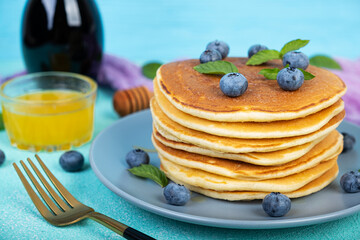 Delicious pancakes with blueberries and honey. Sweet pancakes with fresh berries
