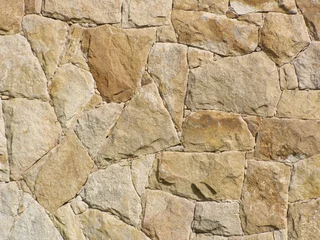 Fotobehang Light brown irregular stone wall. Quartz arenite building cladding. © LimenGD