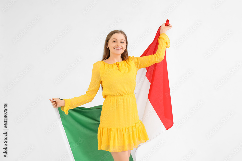 Wall mural Pretty young woman with flag of Italy on white background