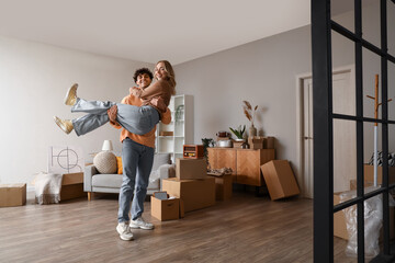 Young couple having fun in room on moving day