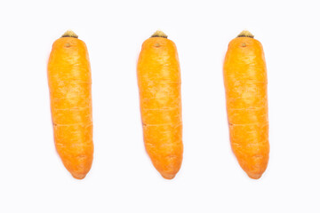 three fresh carrots isolated on white background