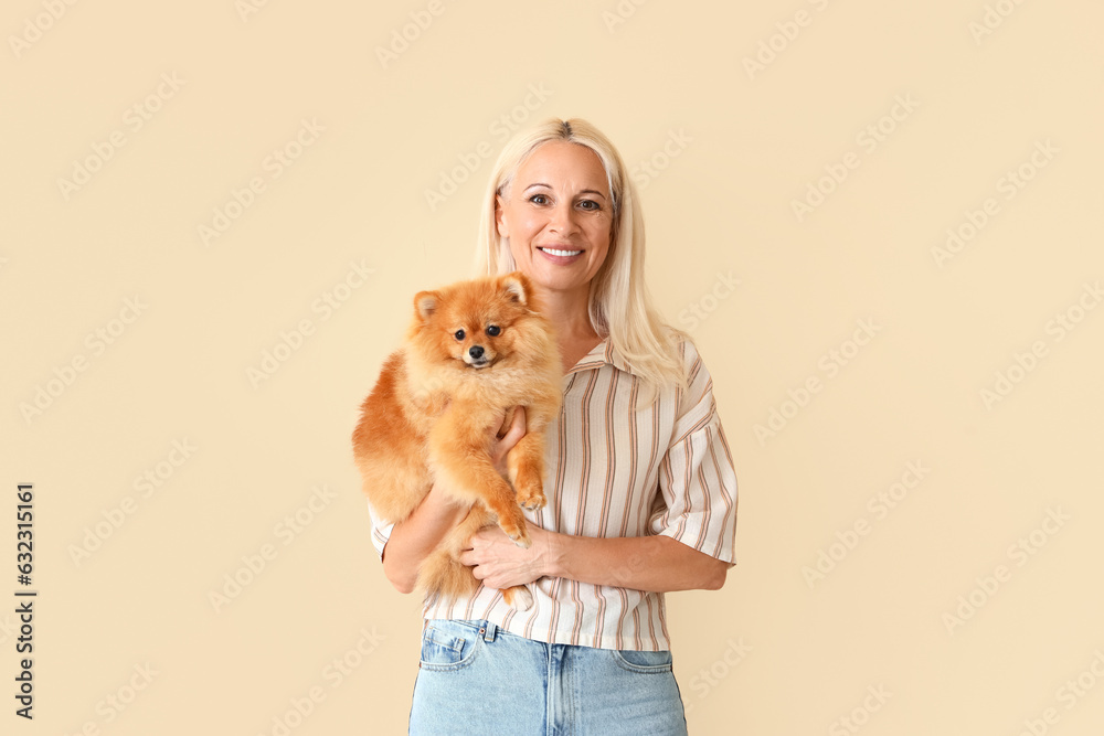 Sticker Mature woman with Pomeranian dog on beige background