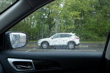 cars parked in parking lot on rainy day